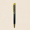 Pen with black and gold accents on a beige background
