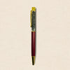 Pen with gold accents on a beige background
