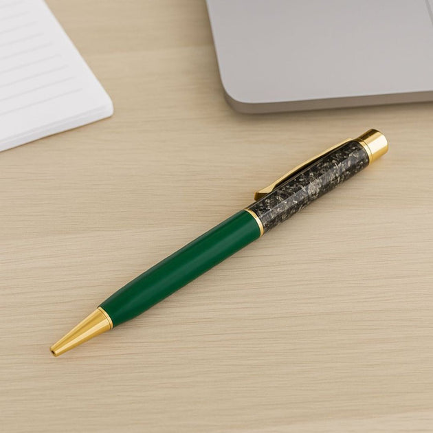 Green pyrite pen with gold accents on a wooden surface