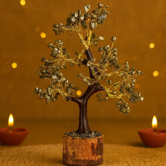 Decorative Pyrite crystal tree with candles on a warm-toned background