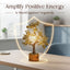 Decorative tree lamp with shield shape on a table, text 'Amplify Positive Energy & Shield against Negativity' above.