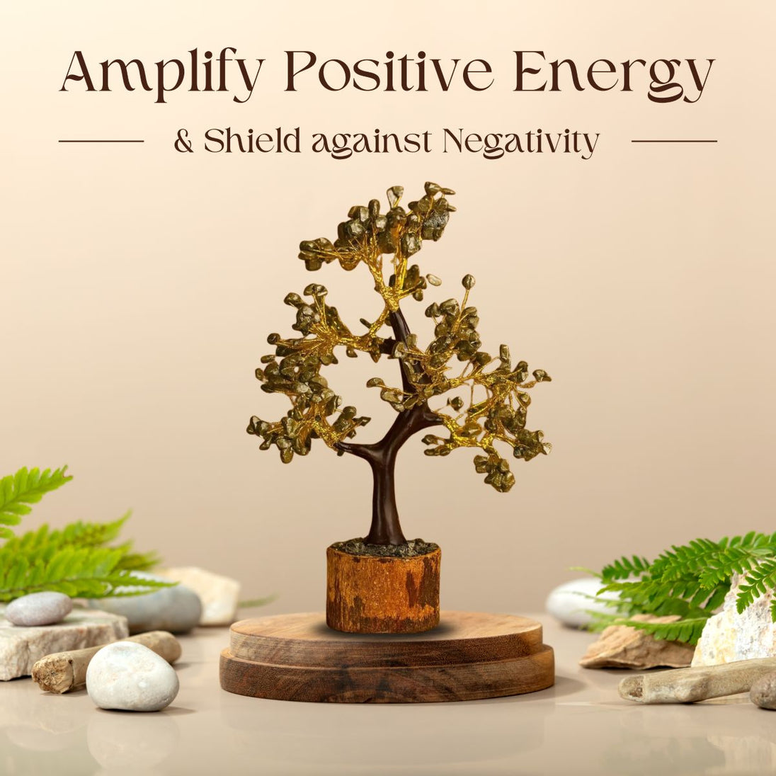 Decorative crystal tree on a wooden base with stones and ferns, promoting positive energy.