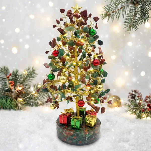 Decorative Christmas tree with lights and ornaments on a snowy background