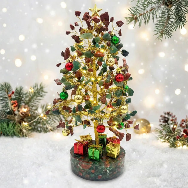 Decorative Christmas tree with lights and ornaments on a snowy background