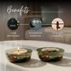 Two decorative candles in glass holders with text on benefits on a blurred background