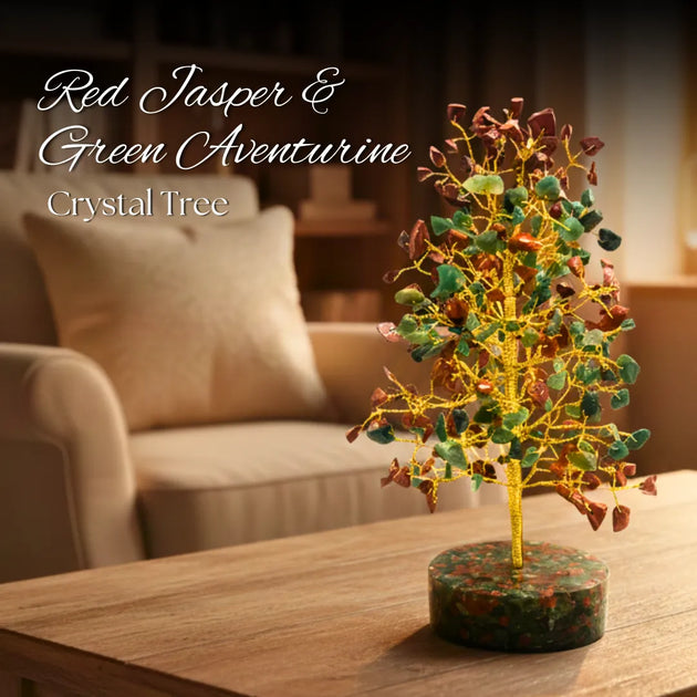Crystal tree with red jasper and green aventurine on a wooden table in a living room setting.