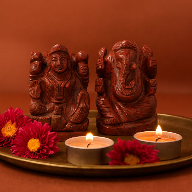 red jasper lakshmi ganesh idol pair on a golden plate with red background