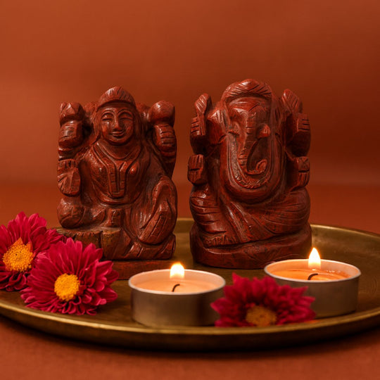 red jasper lakshmi ganesh idol pair on a golden plate with red background