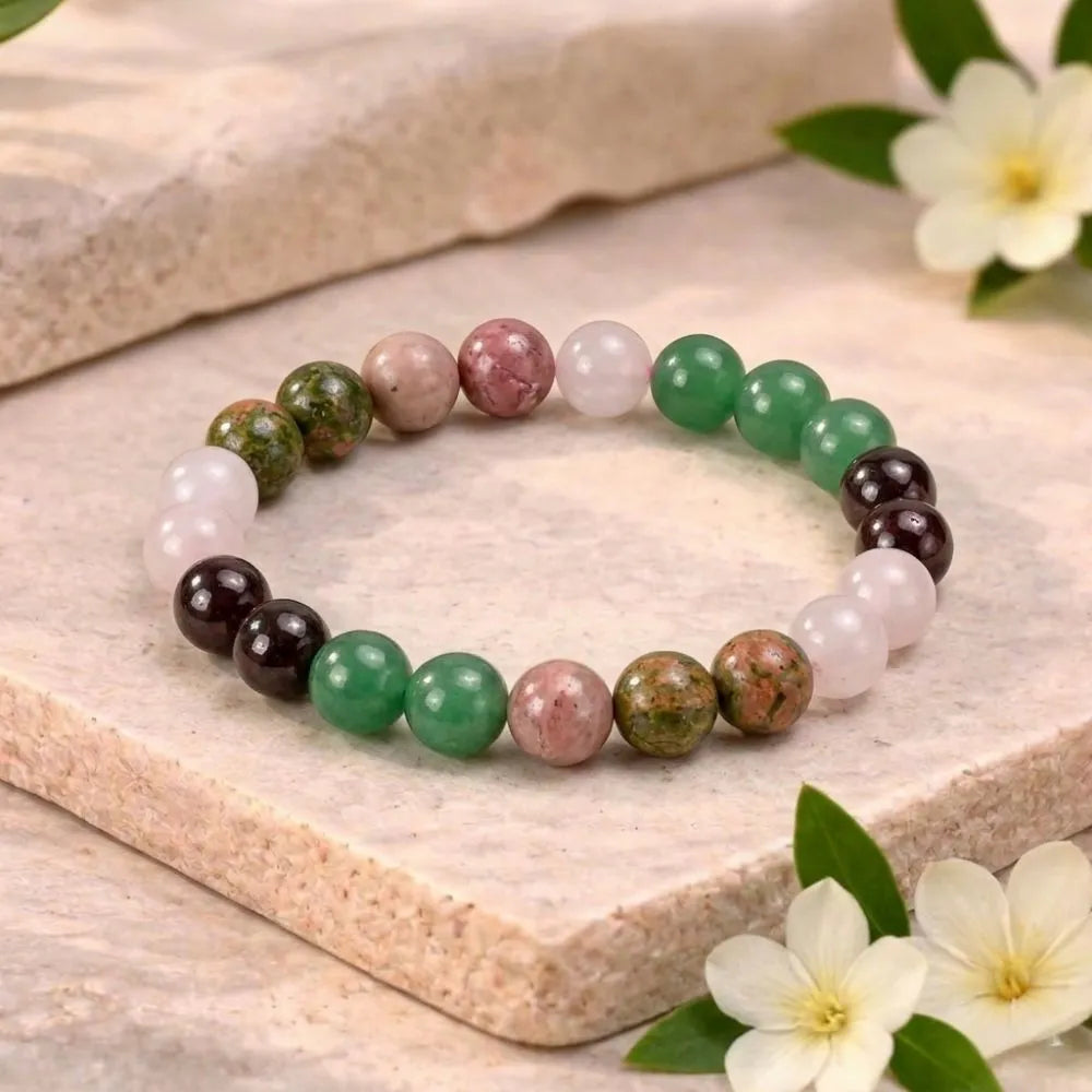 Multicolored beaded bracelet on a stone surface with flowers
