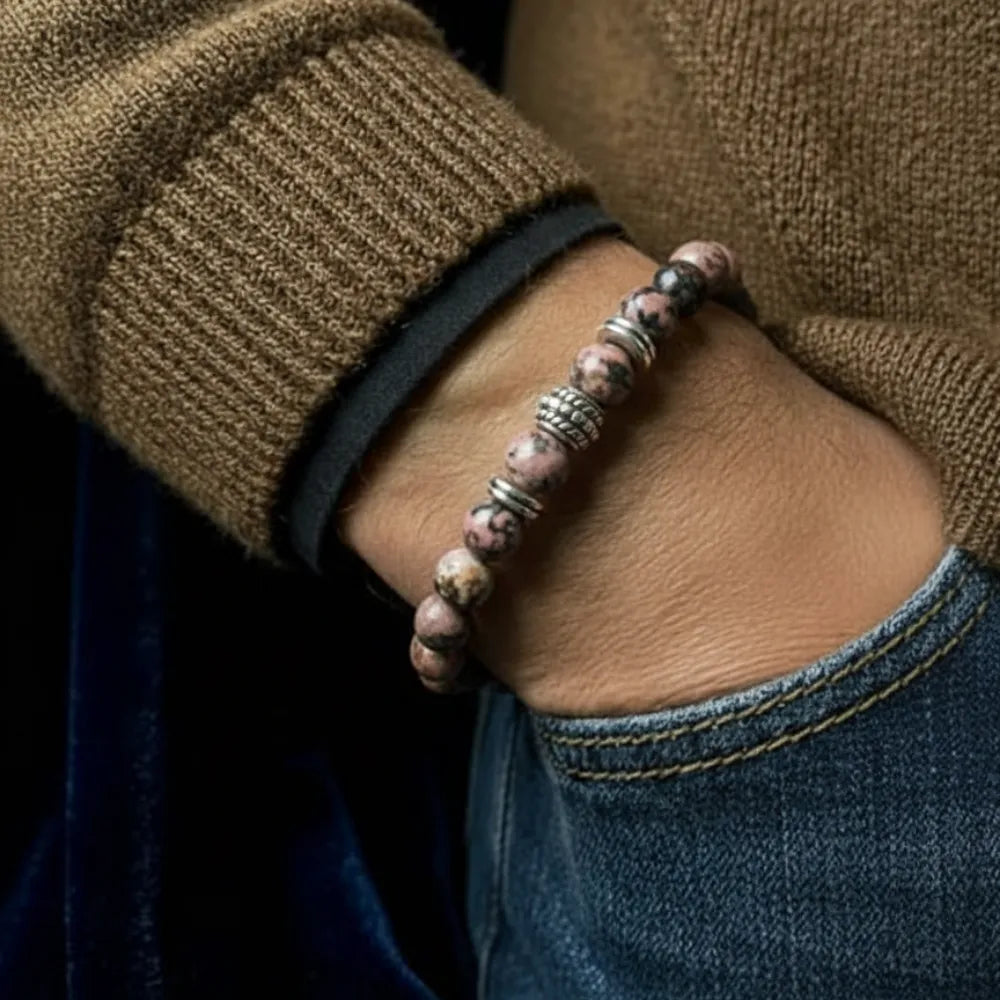 Person wearing a beaded bracelet on a blurred background