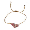 thread bracelet with pink rhodonite stones on a white background