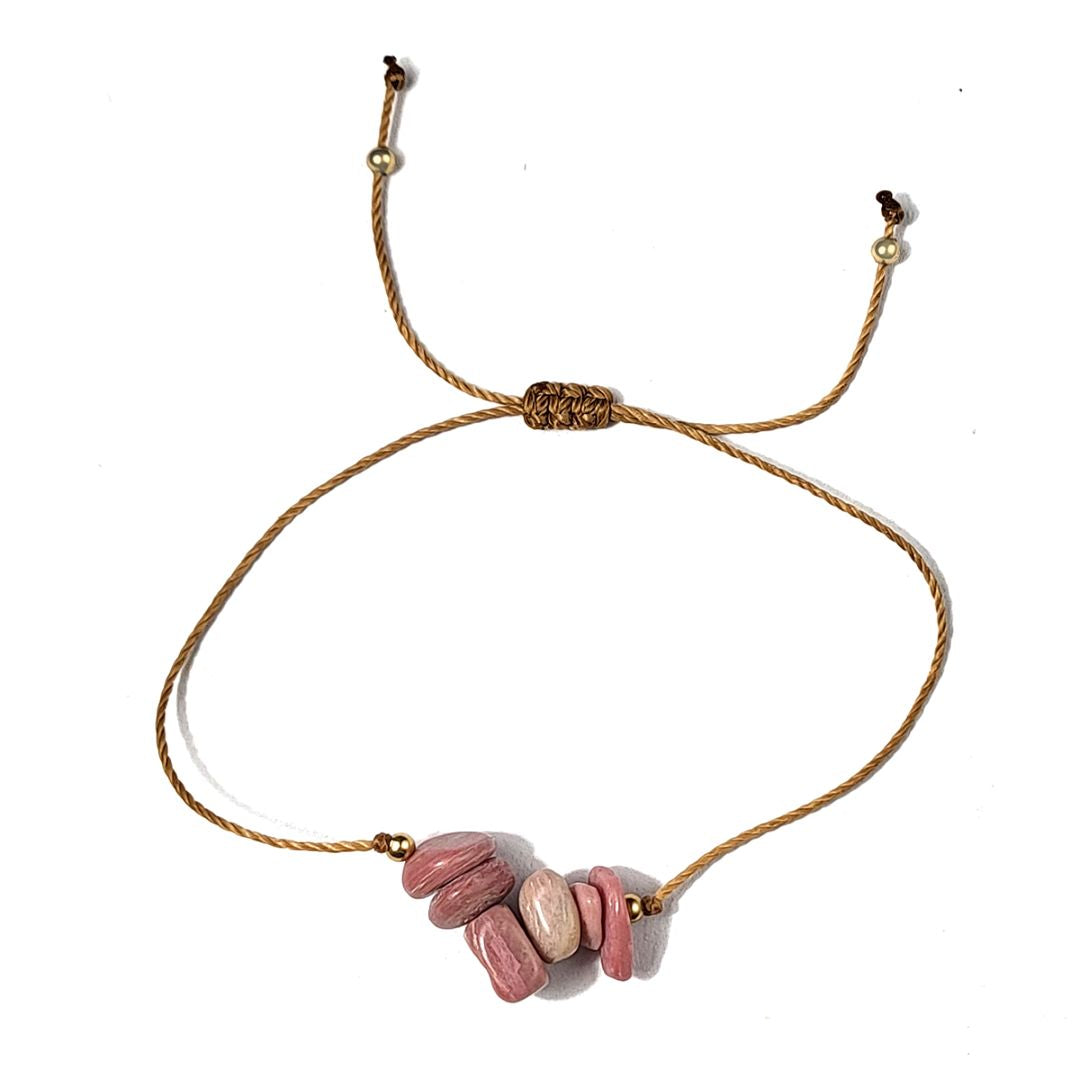 thread bracelet with pink rhodonite stones on a white background