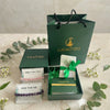 Gift set with 'Calminds' branding on a neutral background with greenery.
