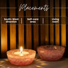 Two pink glass bowls with a lit candle on a wooden background, labeled for placements.