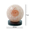 Pink crystal ball with a spiral design on a black stand, accompanied by measurements.