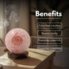 Pink crystal ball with a spiral design on a wooden surface, emitting smoke, with text listing benefits.