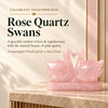 Pair of pink rose quartz birds with necks curved to form a heart