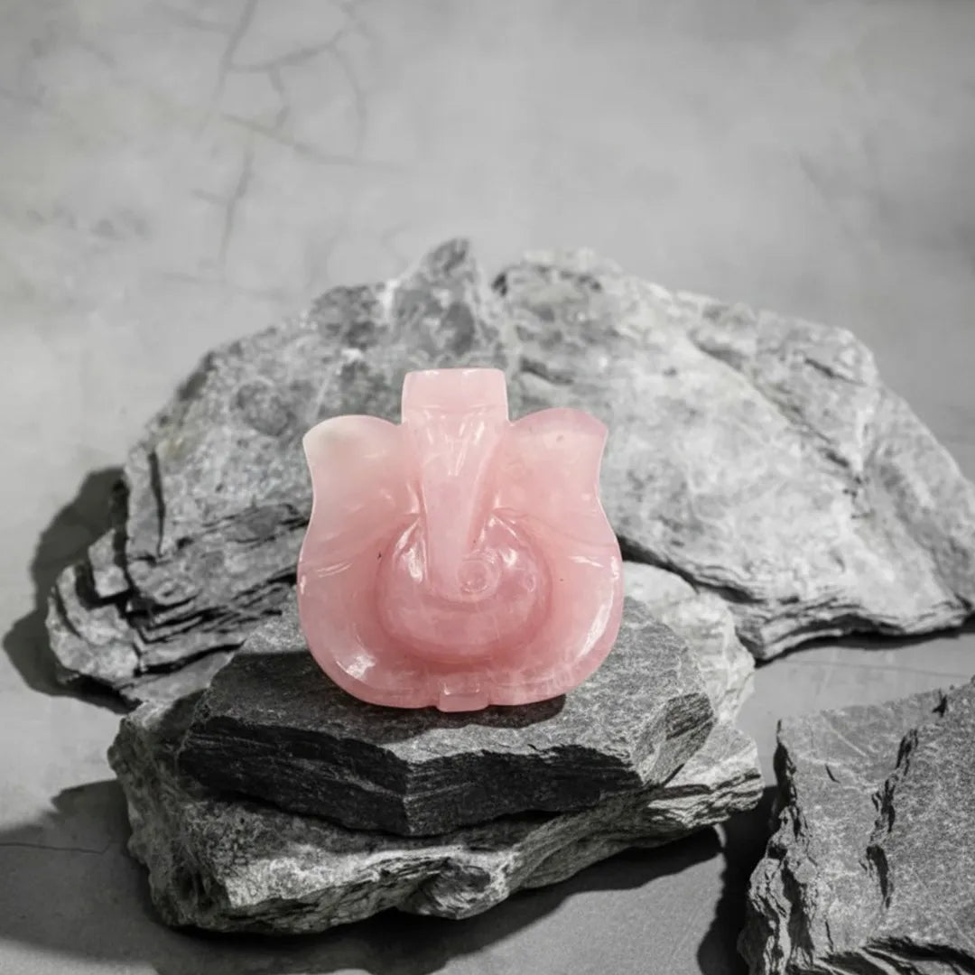 Pink stone sculpture on a gray stone surface