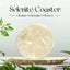Selenite coaster on a wooden stand with plants in the background