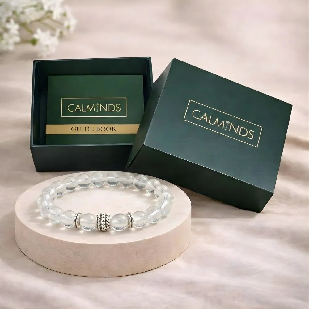 Bracelet on a stand with 'CALMINDS' branded box and guide book in the background.