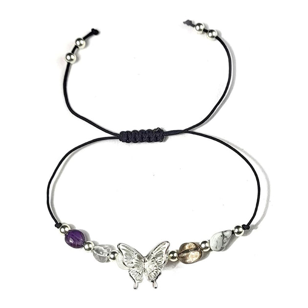 Bracelet with butterfly charm and beads on a white background