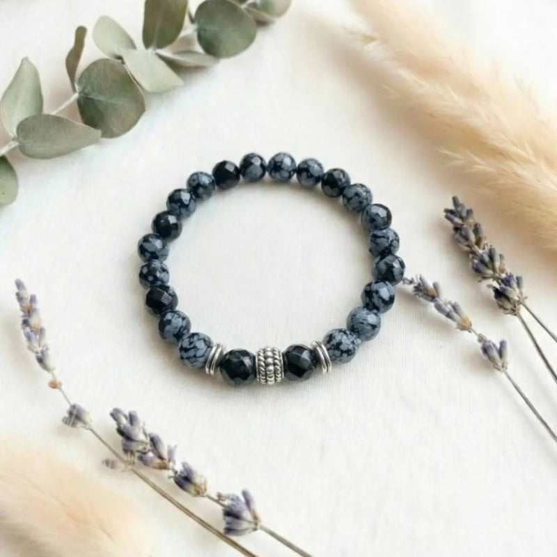 Beaded bracelet with decorative elements on a light background