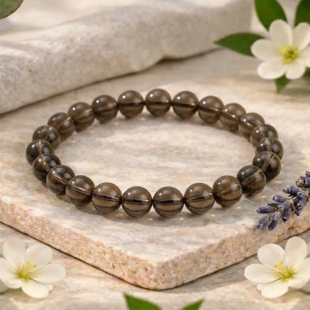 Beaded bracelet on a stone surface with flowers
