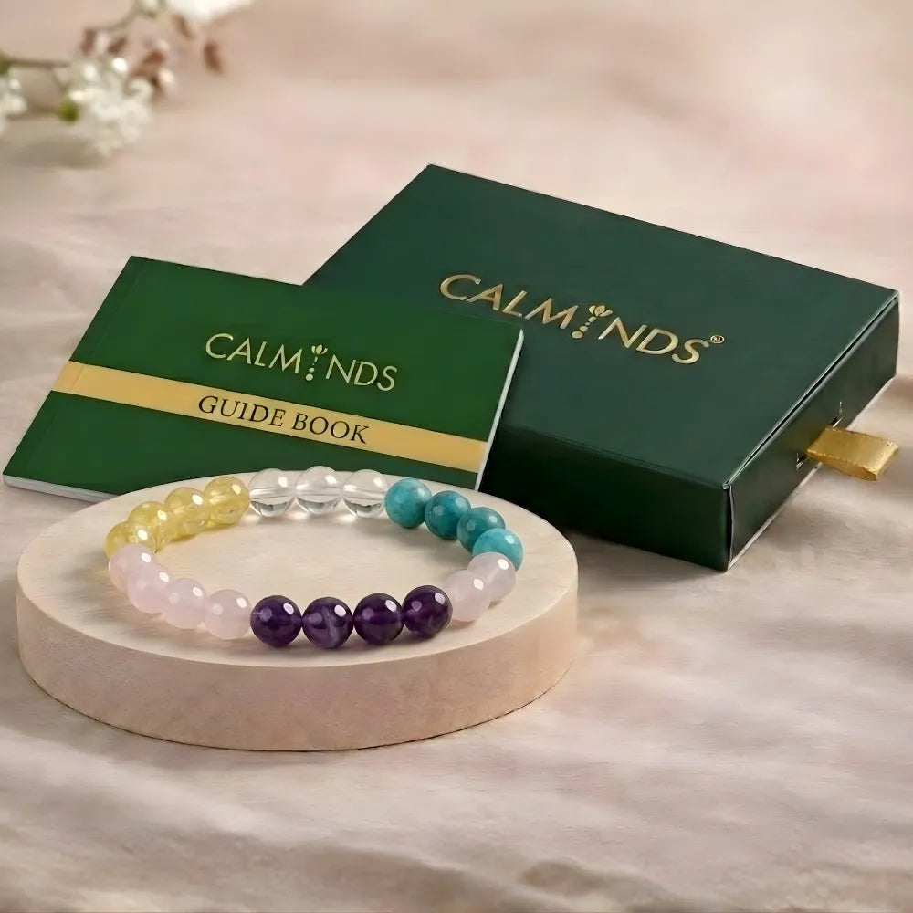 Set of colorful beaded bracelets on a wooden stand with Calminds packaging in the background.