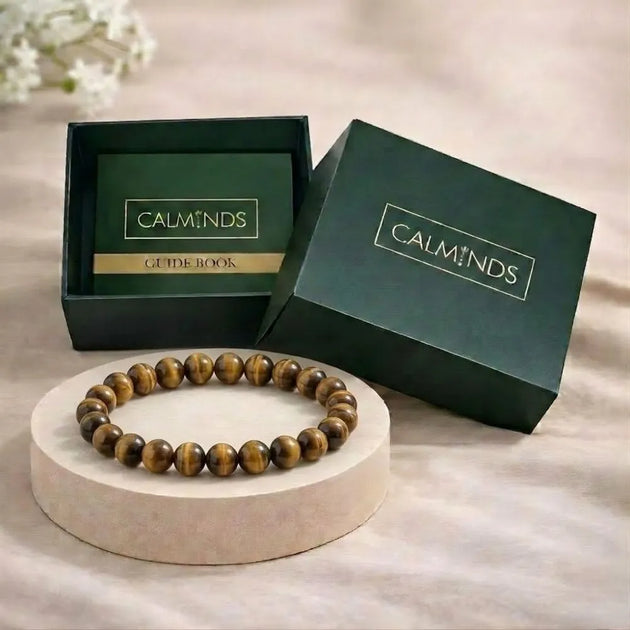 Wooden beaded bracelet on a stand with 'Calminds' branded box in the background