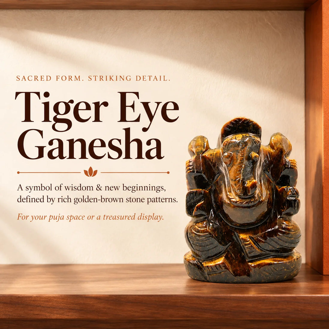 Hand-carved tiger eye Ganesha idol with golden-brown stone bands on a wooden shelf