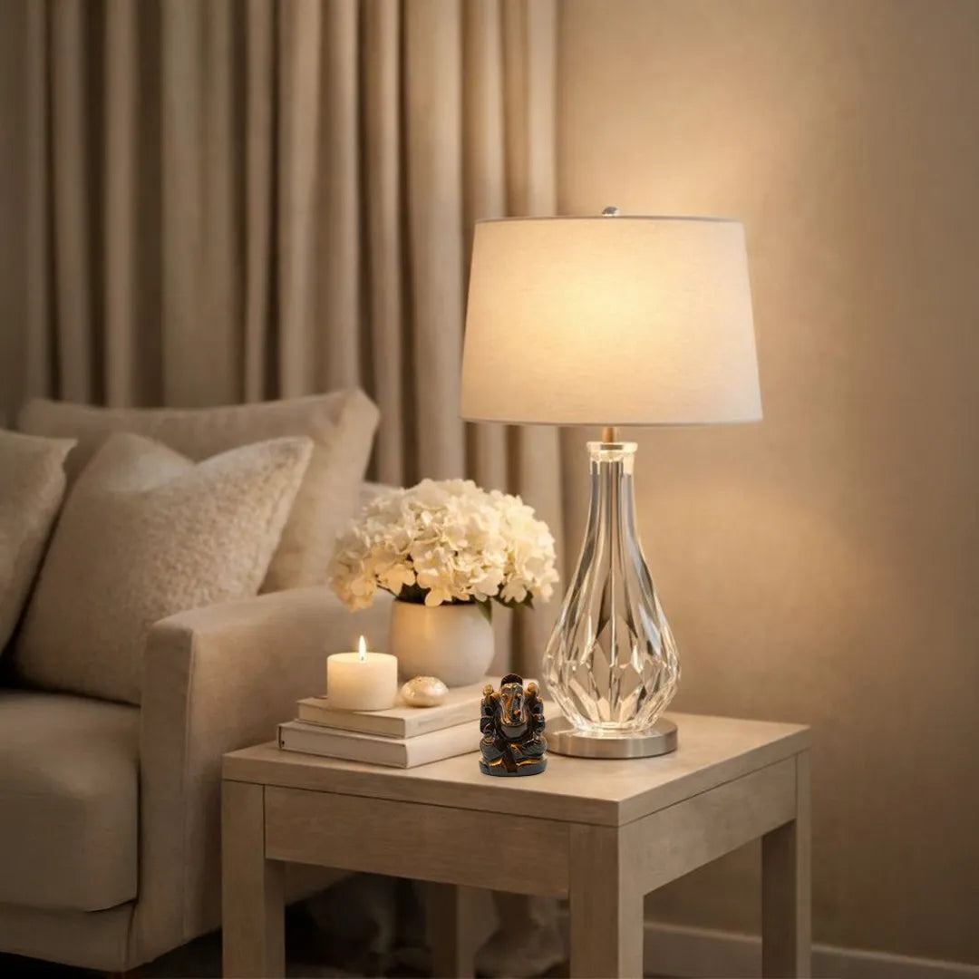 Napkin holder on a wooden surface with a decorative vase and candle in the background.