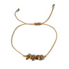 golden thread bracelet with  tiger eye stone beads on a white background
