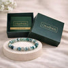 Beaded bracelet on a stand with 'CALMINDS' branded box and guide book in the background.