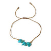golden thread bracelet with turquoise stones on a white background