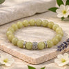 Smoky quartz crystal bracelet on a wrist with text highlighting its benefits.