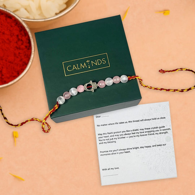 Rakhi with crystals on a green box labeled 'Calminds' with a message card.